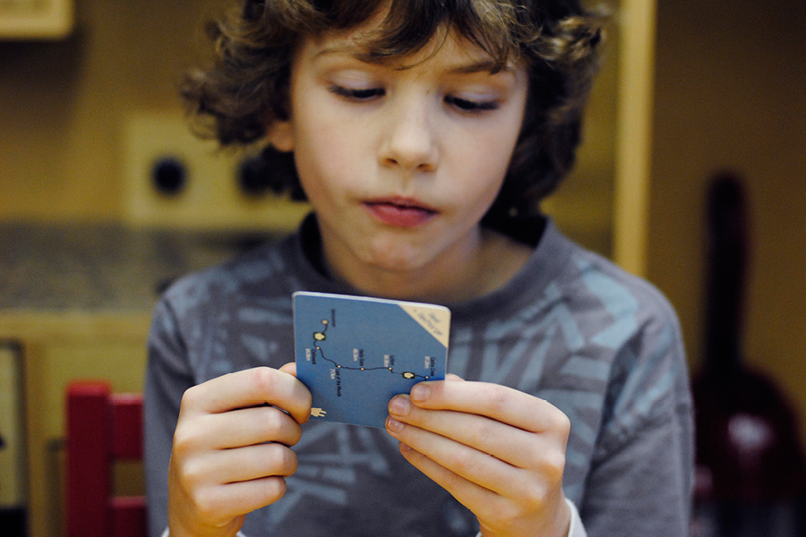 Figure 2. William, co-designer, reading a Quest card prototype